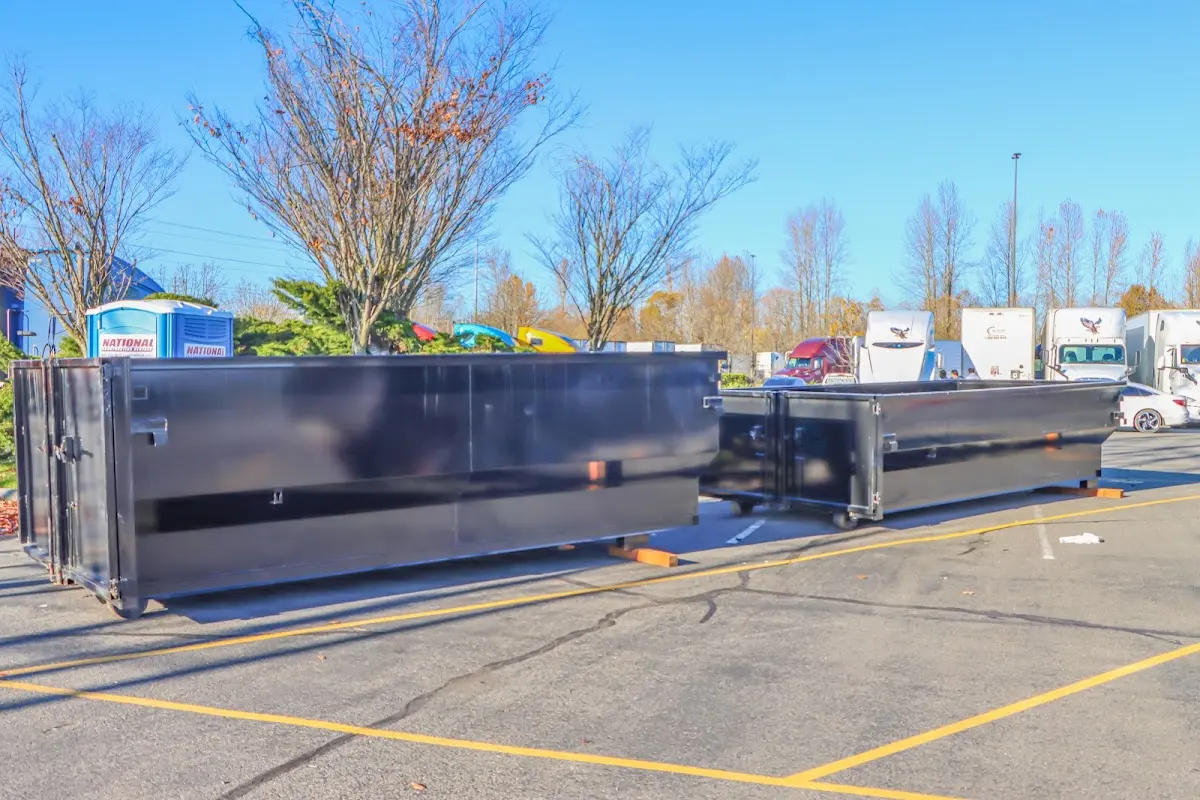 Professional dumpster rental service with roll-off container on residential driveway in Fostoria